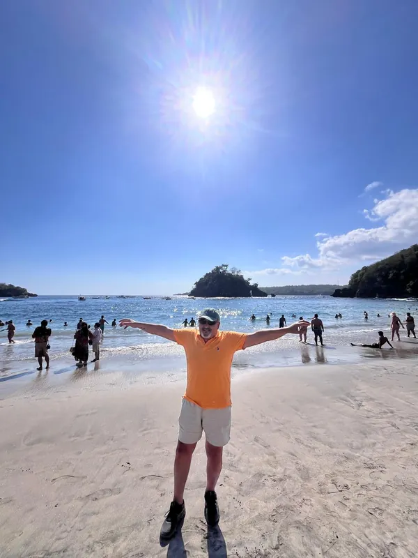 Guest enjoying the white sand of Crystal Bay beach, Nusa Penida